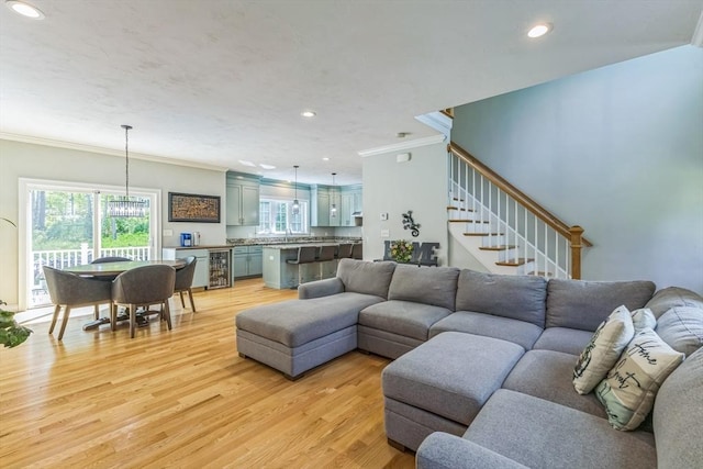 82 Sutton St, Uxbridge, MA 01569 - living area with crown molding, light wood-type flooring, wine cooler, stairway, and recessed lighting