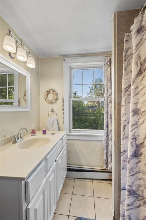 41 Endicott St, Danvers, MA 01923 - full bath with tile patterned flooring, vanity, and a baseboard heating unit