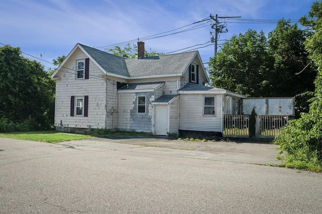 41 Endicott St, Danvers, MA 01923 - view of front facade with a chimney and a shingled roof