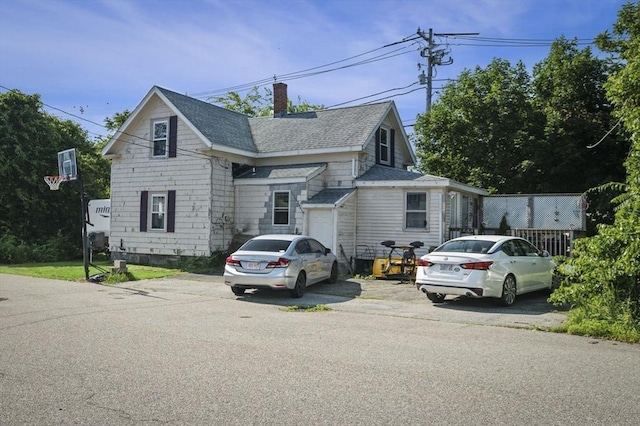 41 Endicott St, Danvers, MA 01923 - view of front of property featuring a shingled roof and a chimney