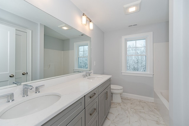 full bathroom featuring shower with separate bathtub, vanity, and toilet