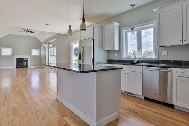 kitchen with white cabinets, stainless steel appliances, and a wealth of natural light