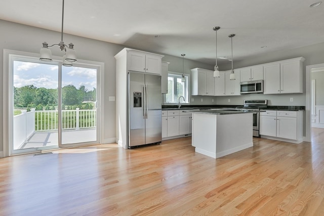 kitchen featuring decorative light fixtures, plenty of natural light, and appliances with stainless steel finishes