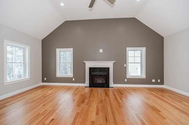 unfurnished living room featuring ceiling fan, light hardwood / wood-style flooring, and high vaulted ceiling