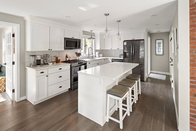 kitchen featuring a center island, stainless steel appliances, white cabinets, and dark wood-type flooring