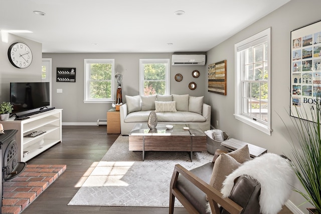 living room with baseboard heating, dark wood-type flooring, and an AC wall unit