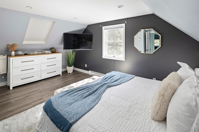 bedroom with a baseboard radiator, hardwood / wood-style flooring, and lofted ceiling with skylight