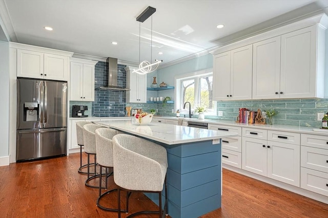 147 Ridge St, Arlington, MA 02474 - kitchen with wall chimney range hood, stainless steel appliances, white cabinets, and dark wood-type flooring