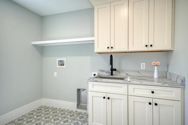 147 Ridge St, Arlington, MA 02474 - laundry room featuring baseboards, electric dryer hookup, a sink, cabinet space, and washer hookup