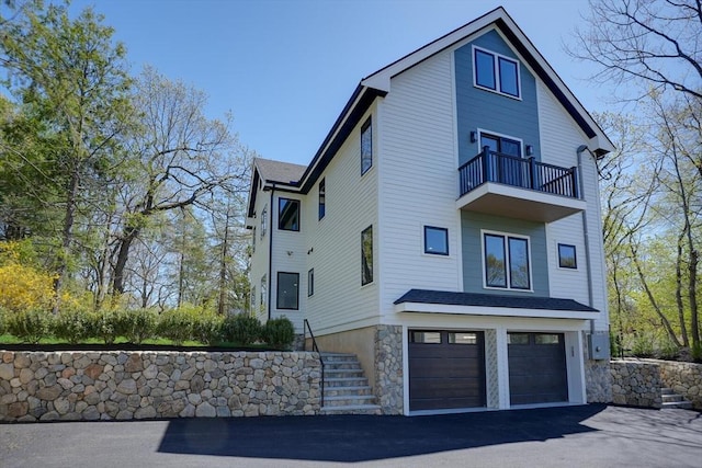 147 Ridge St, Arlington, MA 02474 - view of side of property featuring a garage, a balcony, and driveway