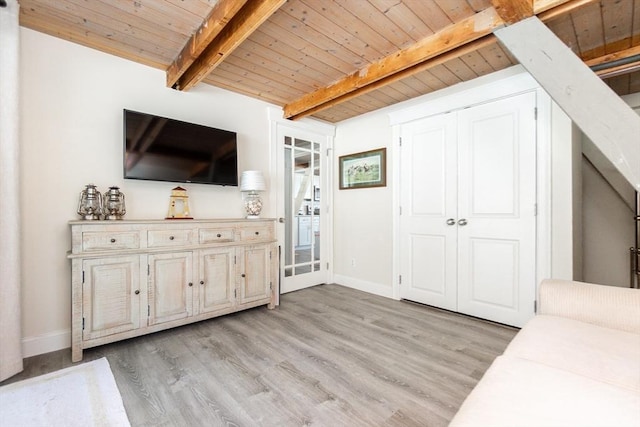 unfurnished living room with wood ceiling, beamed ceiling, and light wood-type flooring