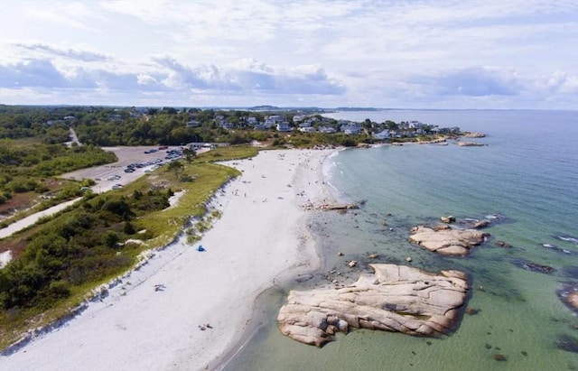 birds eye view of property featuring a water view and a beach view