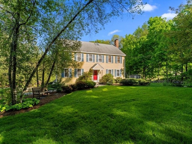 769 Edgell Rd, Framingham, MA 01701 - colonial home featuring a front yard and a chimney