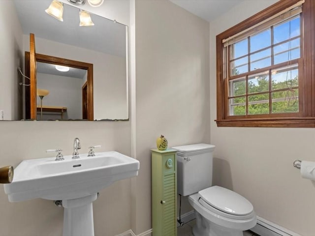 769 Edgell Rd, Framingham, MA 01701 - half bath with baseboard heating, toilet, baseboards, and a sink