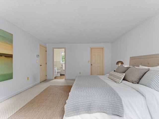 769 Edgell Rd, Framingham, MA 01701 - bedroom with light colored carpet, ensuite bathroom, and baseboards