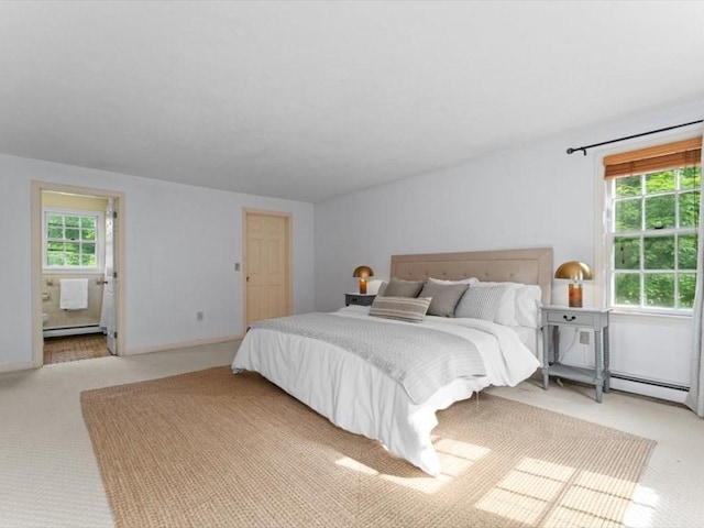 769 Edgell Rd, Framingham, MA 01701 - carpeted bedroom with multiple windows, a baseboard heating unit, and ensuite bathroom
