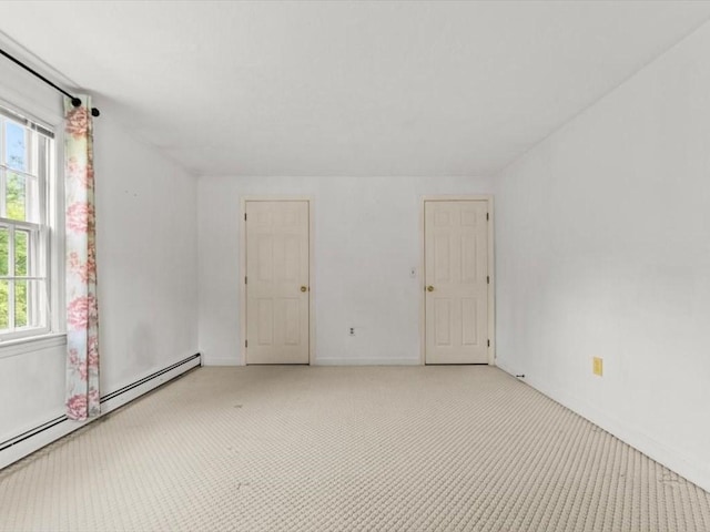 769 Edgell Rd, Framingham, MA 01701 - unfurnished room with a baseboard heating unit, baseboards, and light colored carpet