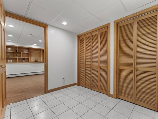 769 Edgell Rd, Framingham, MA 01701 - unfurnished bedroom featuring multiple closets, baseboard heating, a paneled ceiling, baseboards, and recessed lighting