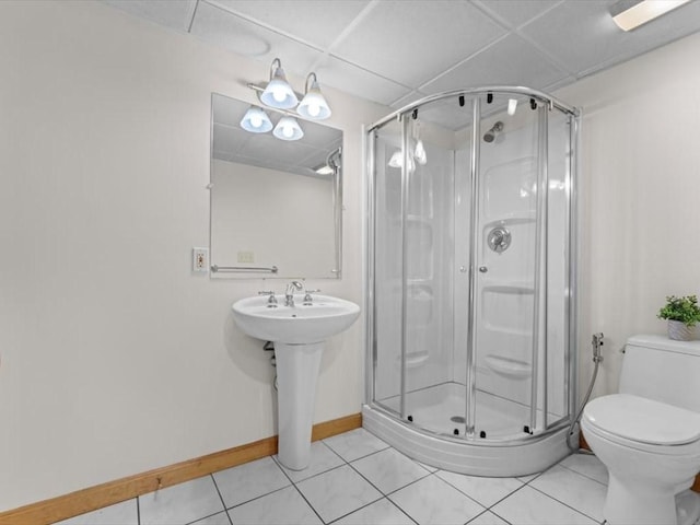 769 Edgell Rd, Framingham, MA 01701 - bathroom with a drop ceiling, a shower stall, toilet, tile patterned floors, and baseboards