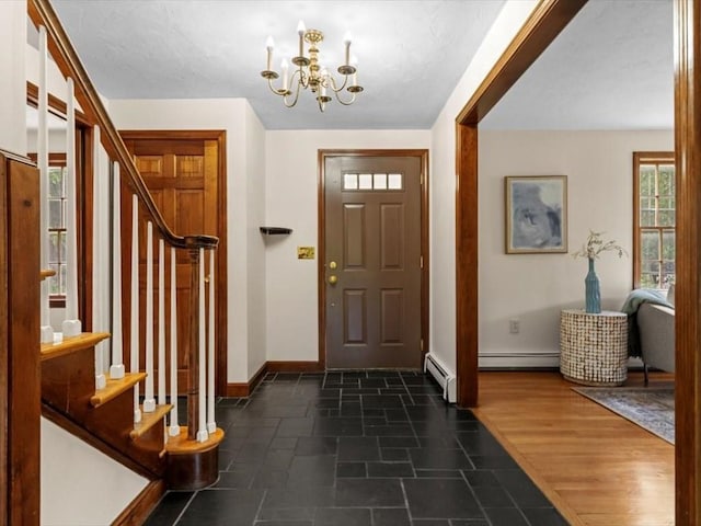 769 Edgell Rd, Framingham, MA 01701 - foyer entrance featuring a chandelier, baseboard heating, stairs, and baseboards