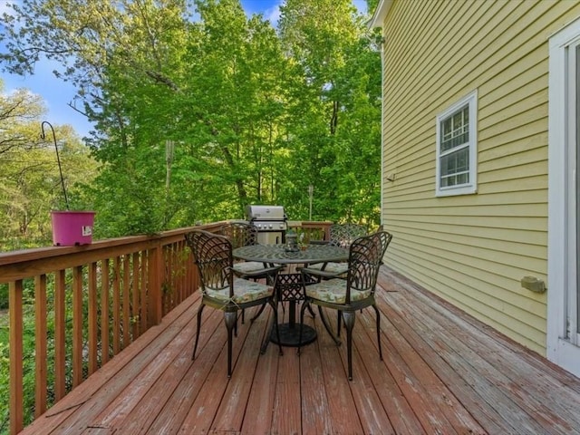 769 Edgell Rd, Framingham, MA 01701 - wooden deck with outdoor dining area and a grill