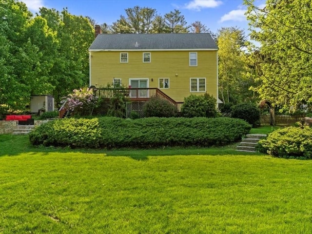 769 Edgell Rd, Framingham, MA 01701 - rear view of property featuring a chimney, a deck, a lawn, and stairs