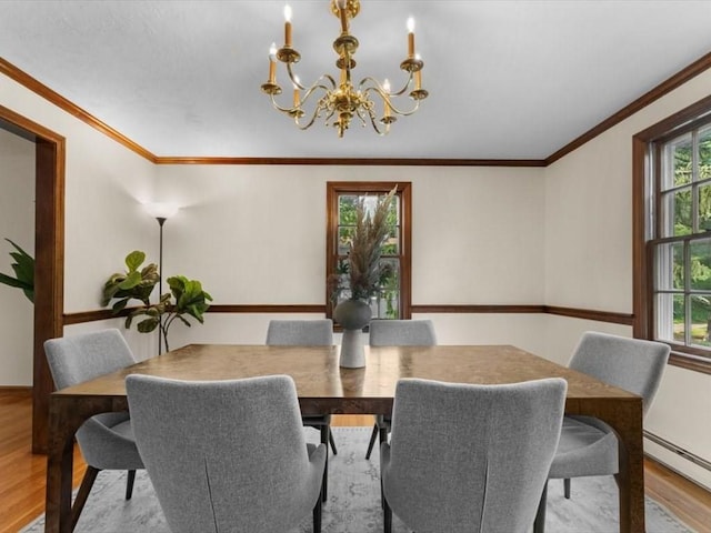 769 Edgell Rd, Framingham, MA 01701 - dining room featuring a chandelier, wood finished floors, a baseboard radiator, and crown molding