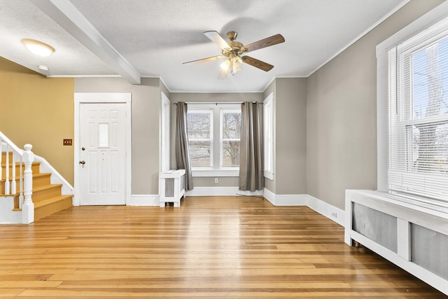 entryway with crown molding, hardwood / wood-style flooring, and ceiling fan