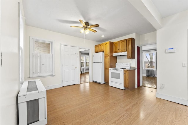 kitchen featuring ceiling fan, white appliances, radiator, and light hardwood / wood-style floors