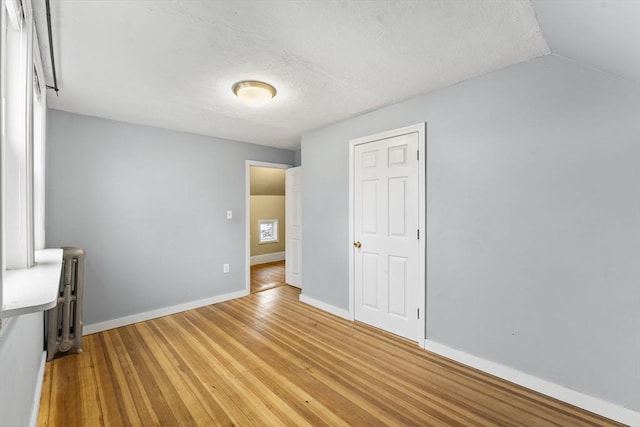 unfurnished bedroom featuring hardwood / wood-style flooring and a textured ceiling