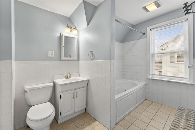 bathroom featuring tile patterned flooring, vanity, tile walls, and toilet