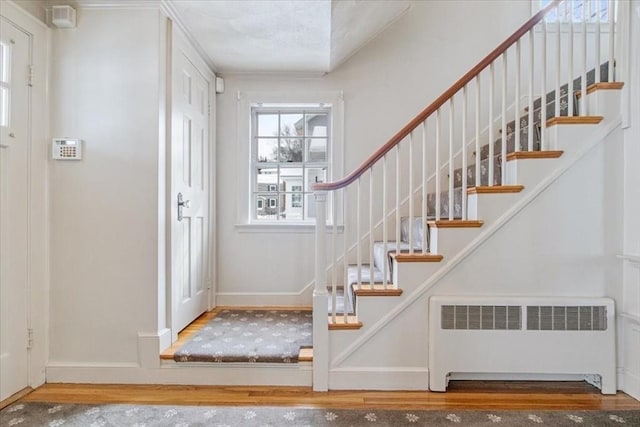 entryway with hardwood / wood-style floors and radiator