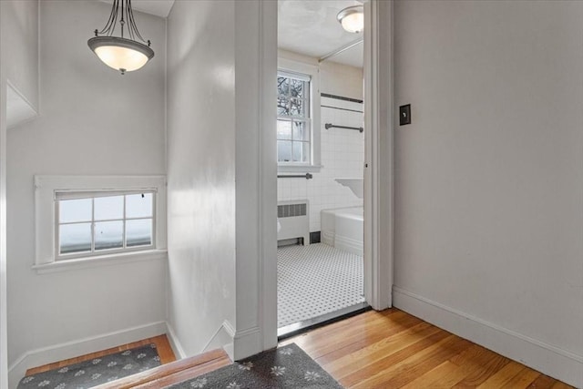 interior space with light wood-type flooring and radiator