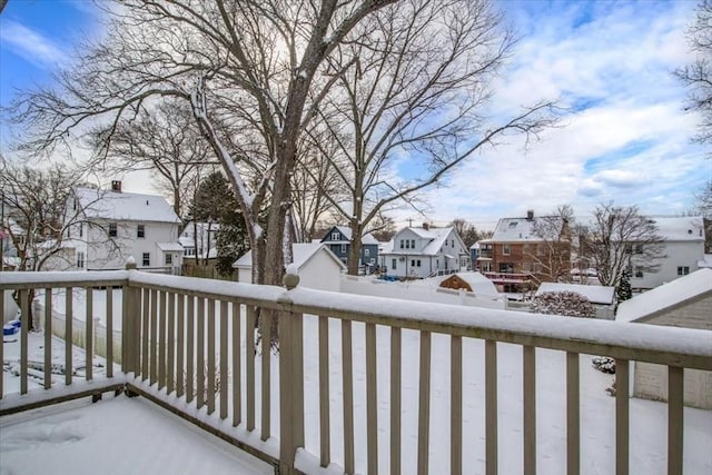 view of snow covered back of property