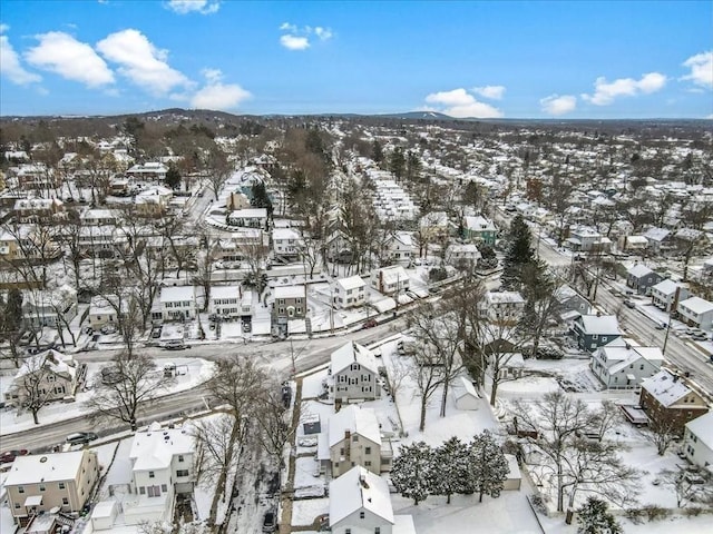 snowy aerial view featuring a mountain view