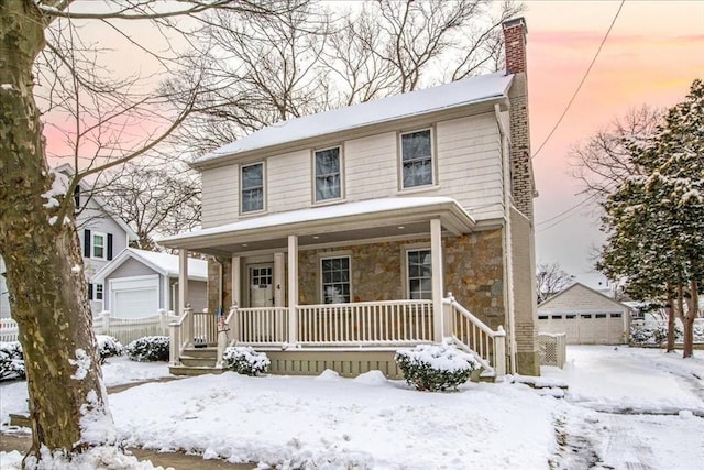 front facade featuring an outdoor structure, a porch, and a garage