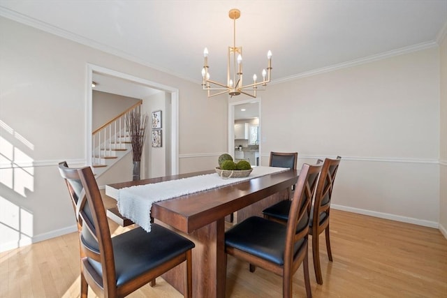 dining area featuring light wood-style floors, crown molding, stairway, and baseboards