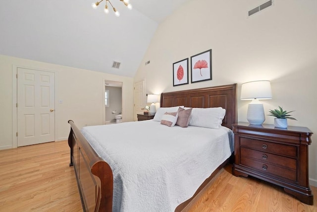 bedroom featuring ensuite bathroom, high vaulted ceiling, light wood-type flooring, and visible vents