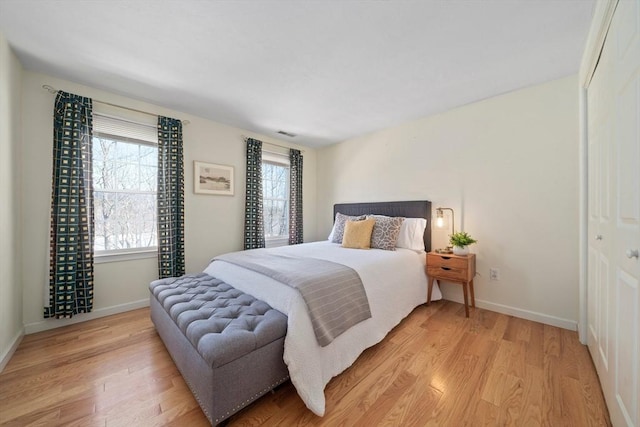 bedroom featuring light wood-type flooring and baseboards