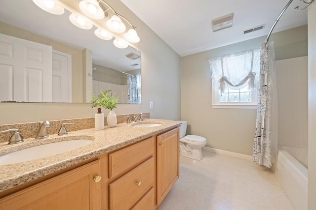 bathroom featuring visible vents, a sink, toilet, and double vanity