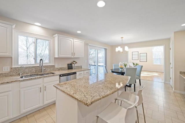 kitchen featuring a center island, a sink, stainless steel dishwasher, and recessed lighting