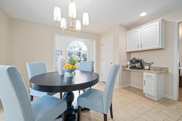 dining space with a chandelier and baseboards