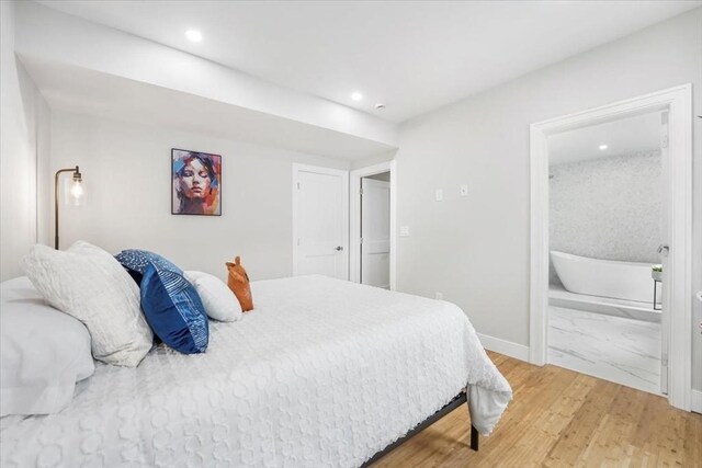 86 Cypress St Unit 8-6, Watertown, MA 02472 - bedroom featuring baseboards, light wood-type flooring, recessed lighting, and connected bathroom