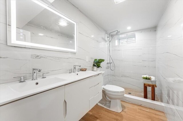 86 Cypress St Unit 8-6, Watertown, MA 02472 - bathroom featuring toilet, a marble finish shower, double vanity, and wood finished floors