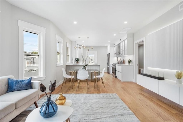 86 Cypress St Unit 8-6, Watertown, MA 02472 - living room with light wood finished floors, recessed lighting, a chandelier, and baseboards