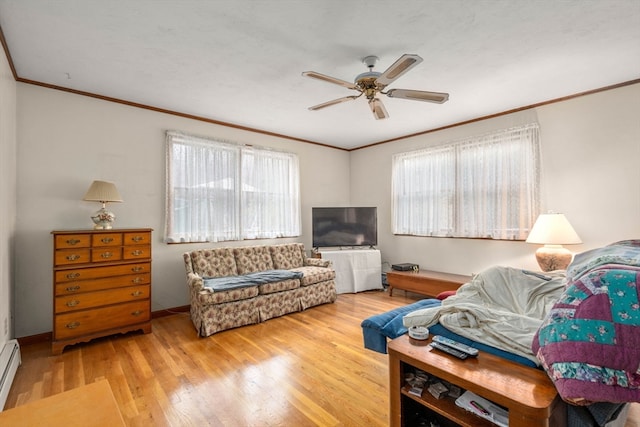 living room with hardwood / wood-style floors, baseboard heating, ceiling fan, and crown molding