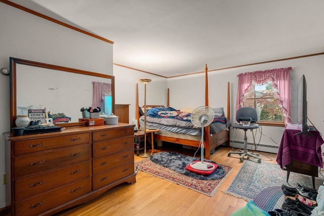 bedroom with hardwood / wood-style floors, a baseboard radiator, and crown molding