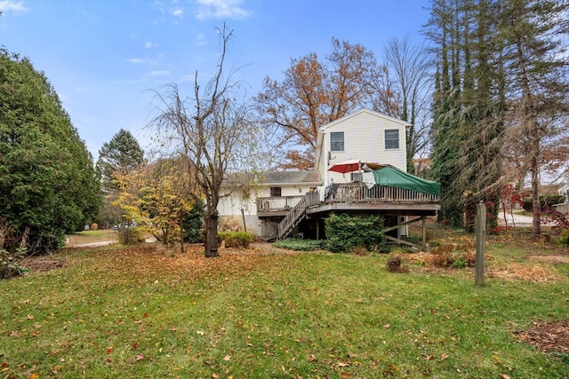 back of property featuring a lawn and a wooden deck