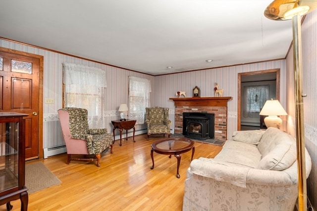 living room with a baseboard radiator, hardwood / wood-style flooring, and crown molding