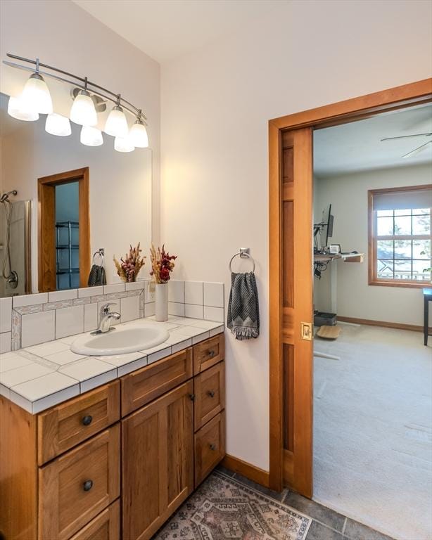 bathroom featuring baseboards and vanity